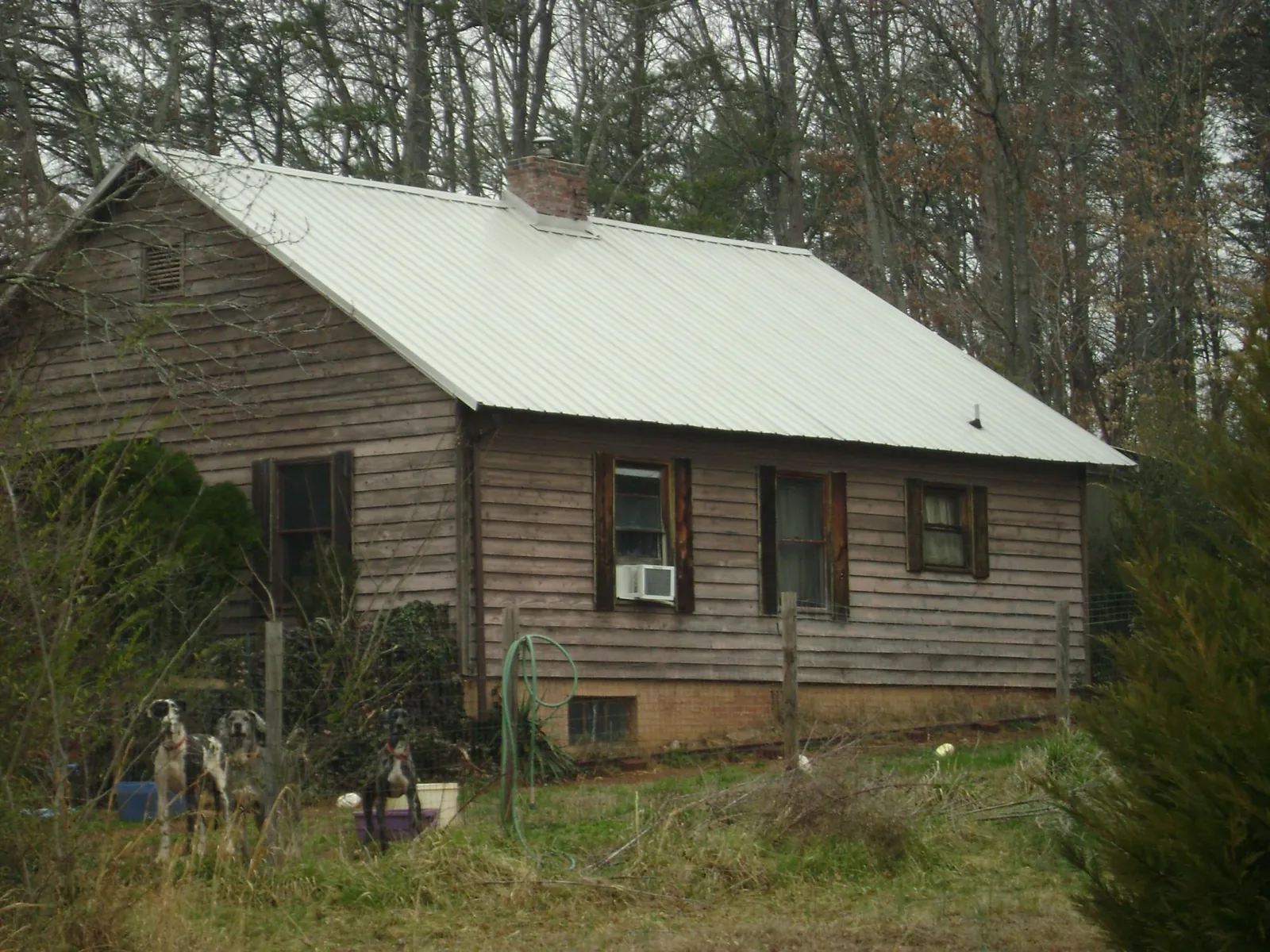 White metal roof on an old wood sided farmhouse, from a Metal Roof Installation job in Griffin